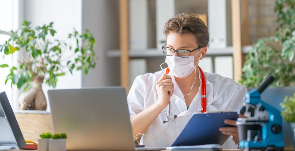 doctor is talking with somebody by laptop